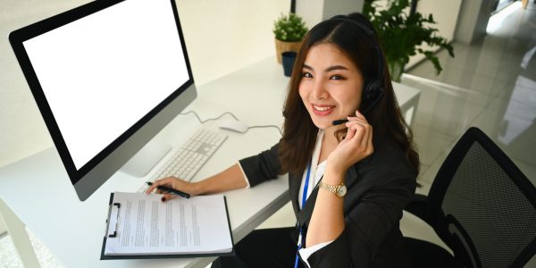 Beautiful asian woman working at call center office to help people with telemarketing assistance.